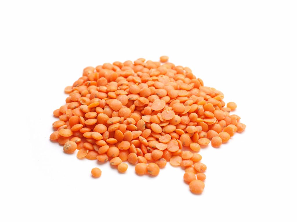 Organic red lentils on a white studio background, healthy food concept
